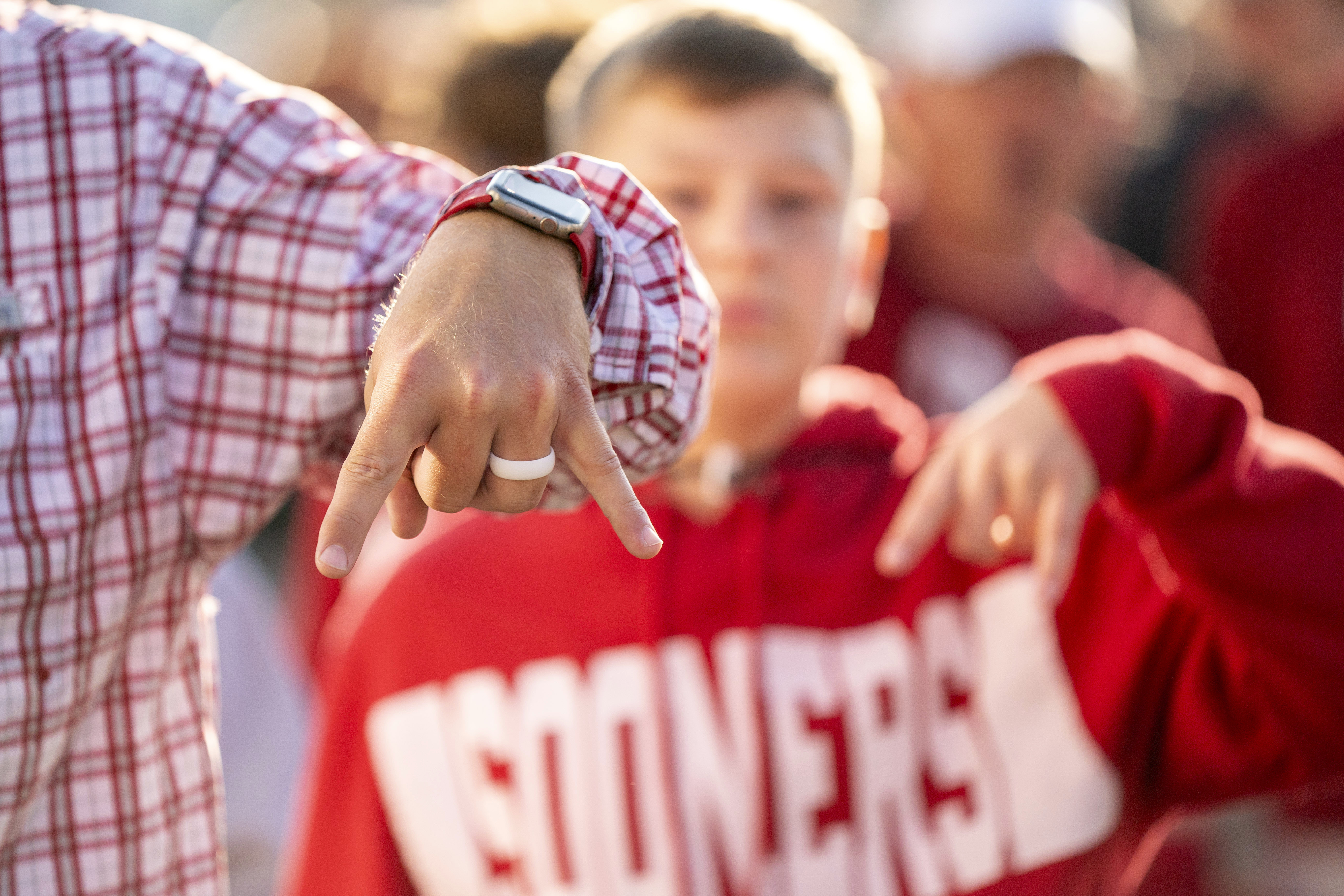 FILE - Oklahoma fans flash the "horns down" hand sign before an NCAA college football game against Texas at the Cotton Bowl, Oct. 7, 2023, in Dallas. Flashing a "horns down" hand signal while playing Texas won't automatically draw a penalty in the Southeastern Conference, officials said Tuesday, July 16, 2024.