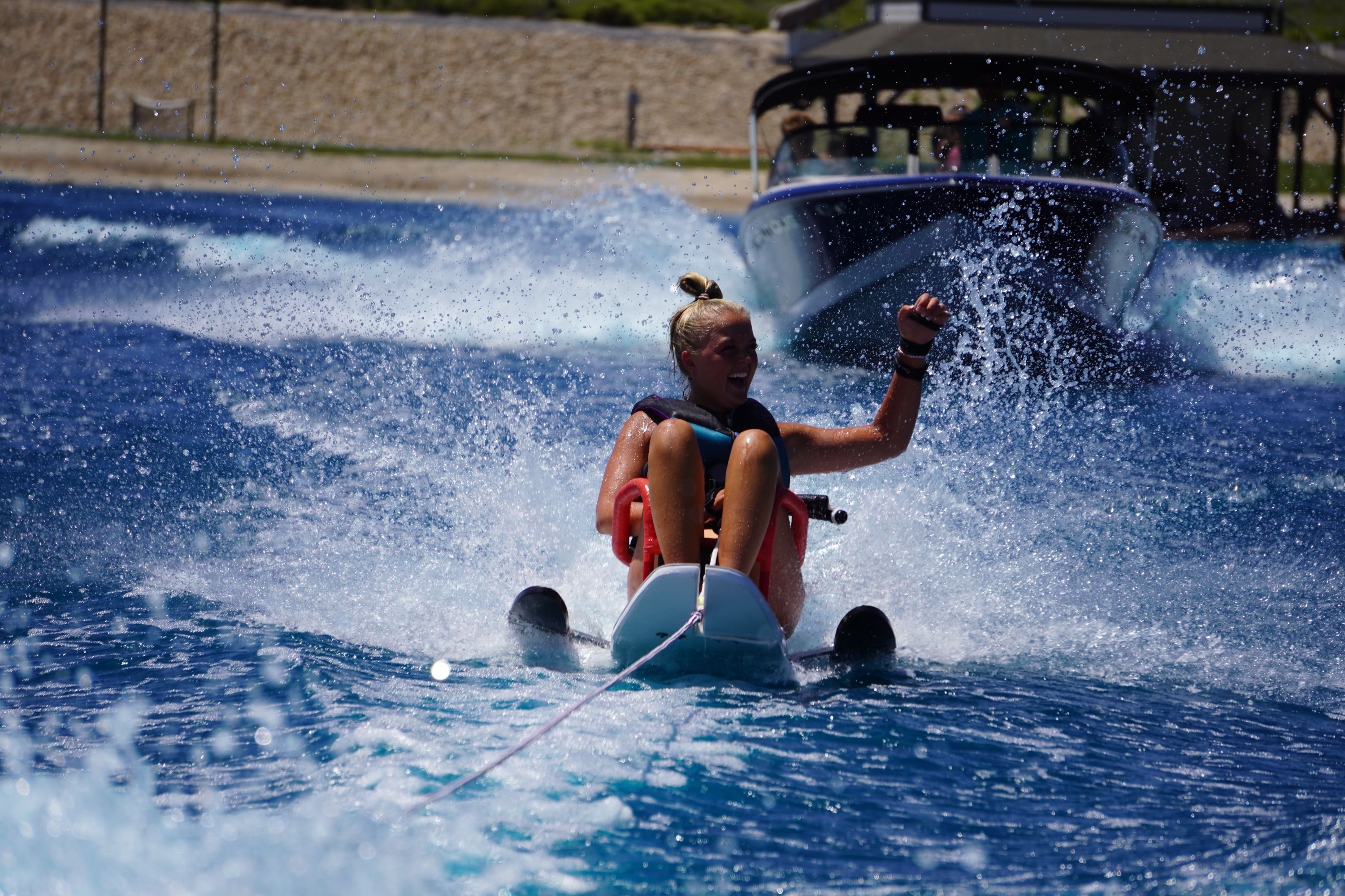 Emily Traveller, who was paralyzed from the waist down following an ATV accident in 2022, uses an adaptive ski to water ski in July 2023.