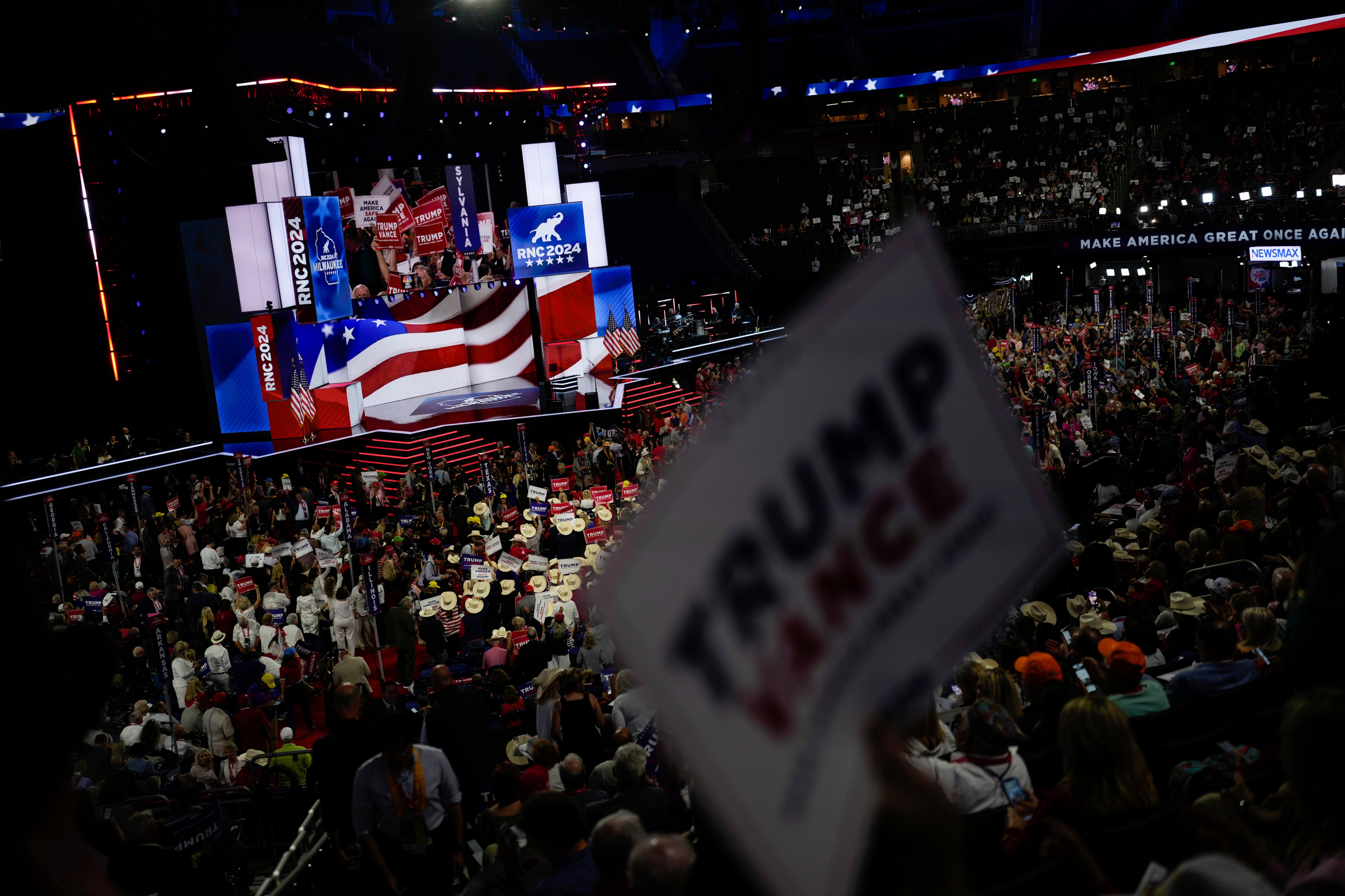 A person holds up a sign during the Republican National Convention Tuesday in Milwaukee.