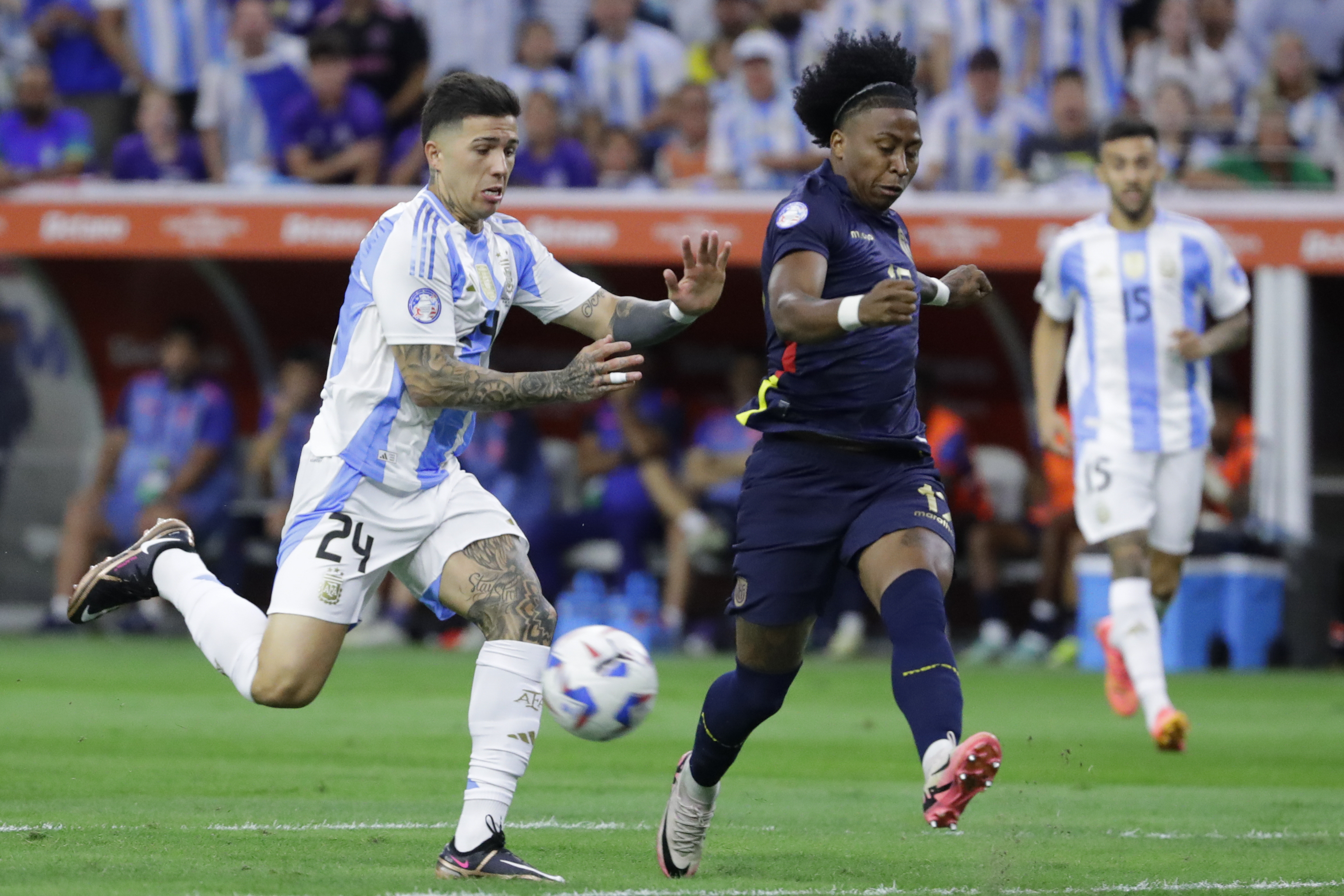 FILE - Ecuador's Angelo Preciado, right, and Argentina's Enzo Fernandez battle for the ball during a Copa America quarterfinal soccer match in Houston, Thursday, July 4, 2024. Chelsea has begun disciplinary action after midfielder Enzo Fernandez was involved in a video where members of Argentina's Copa America-winning squad appeared to sing about French players with African heritage.