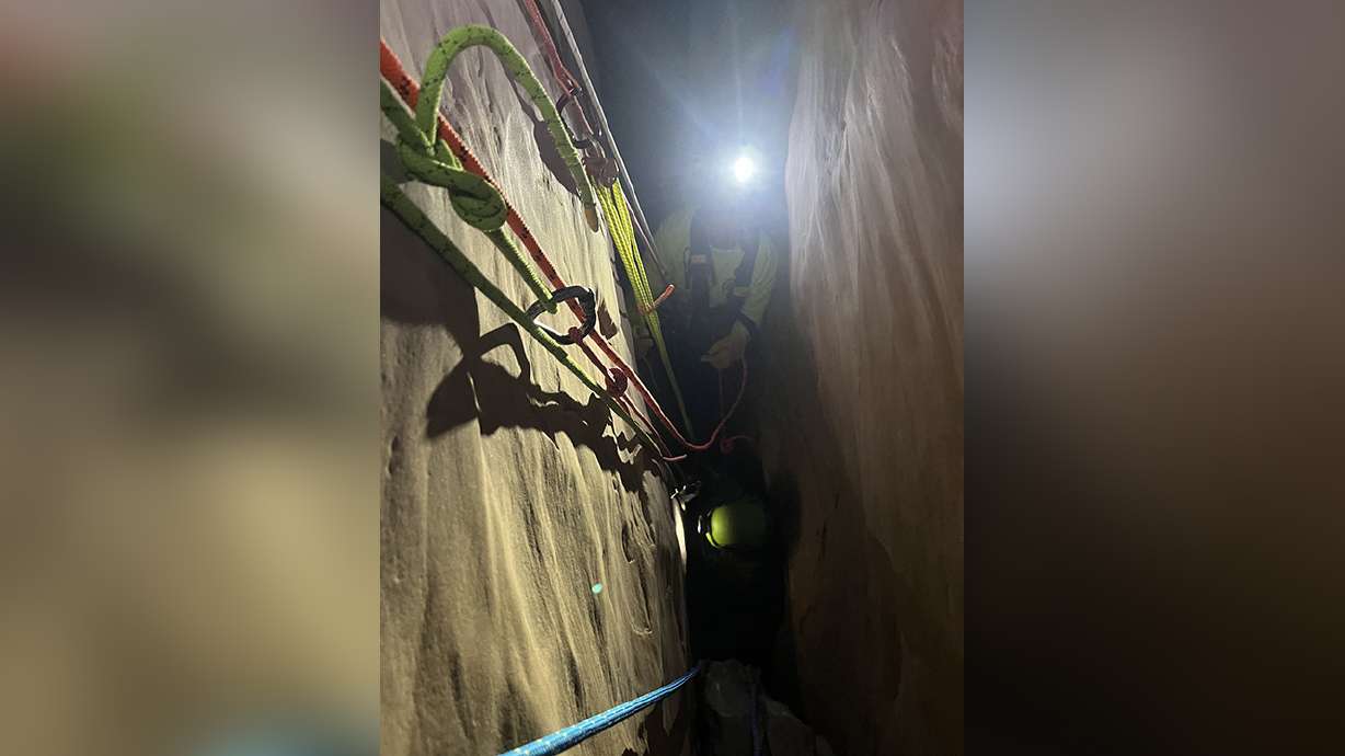 Emery County's search and rescue team and Department of Public Safety officials work to rescue a family stuck in Zero Gravity slot canyon on Monday.
