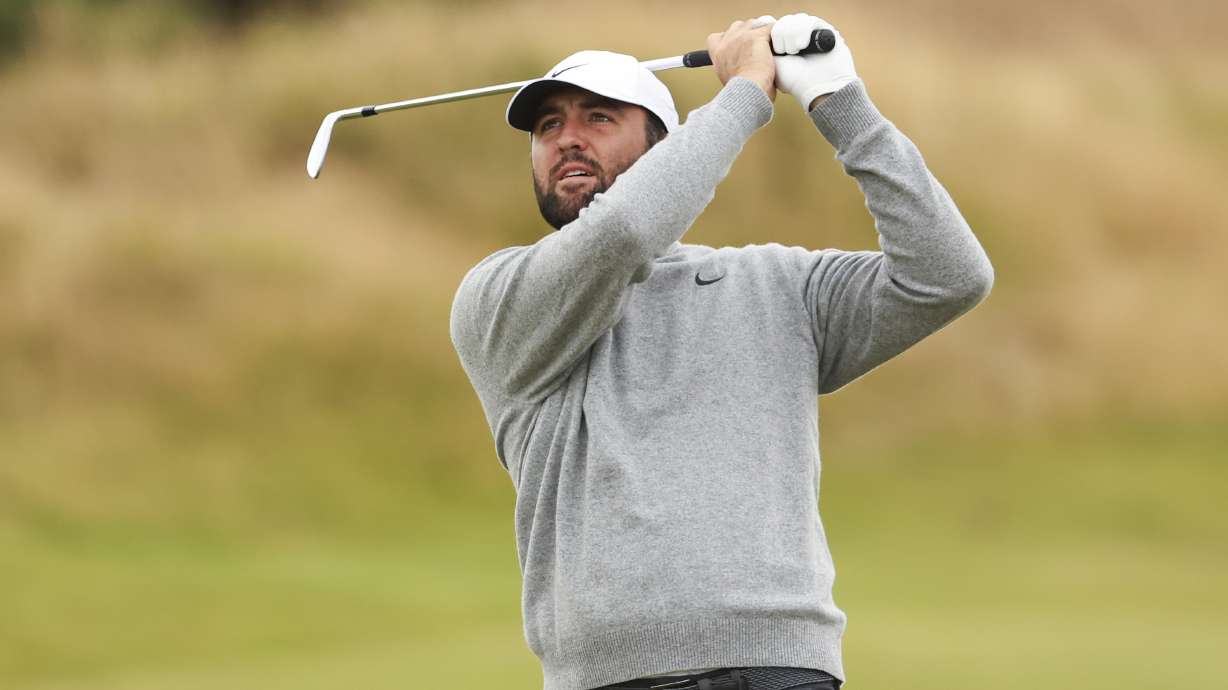 Scottie Scheffler of the United States watches his approach shot into the 11th hole during a practice round ahead of the British Open Golf Championships at Royal Troon golf club in Troon, Scotland, Wednesday, July 17, 2024.