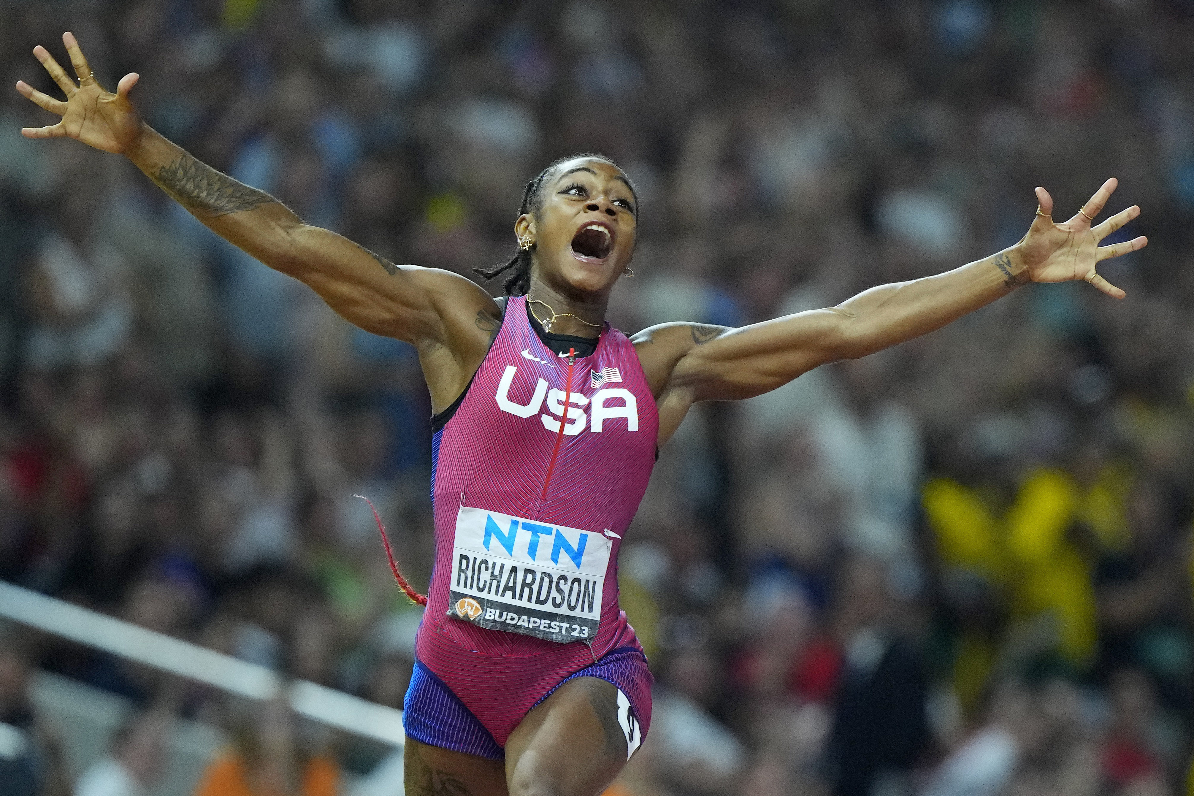 FILE - Sha'Carri Richardson, of the United States, celebrates after winning the gold medal in the final of the Women's 100-meters during the World Athletics Championships in Budapest, Hungary, Aug. 21, 2023. 