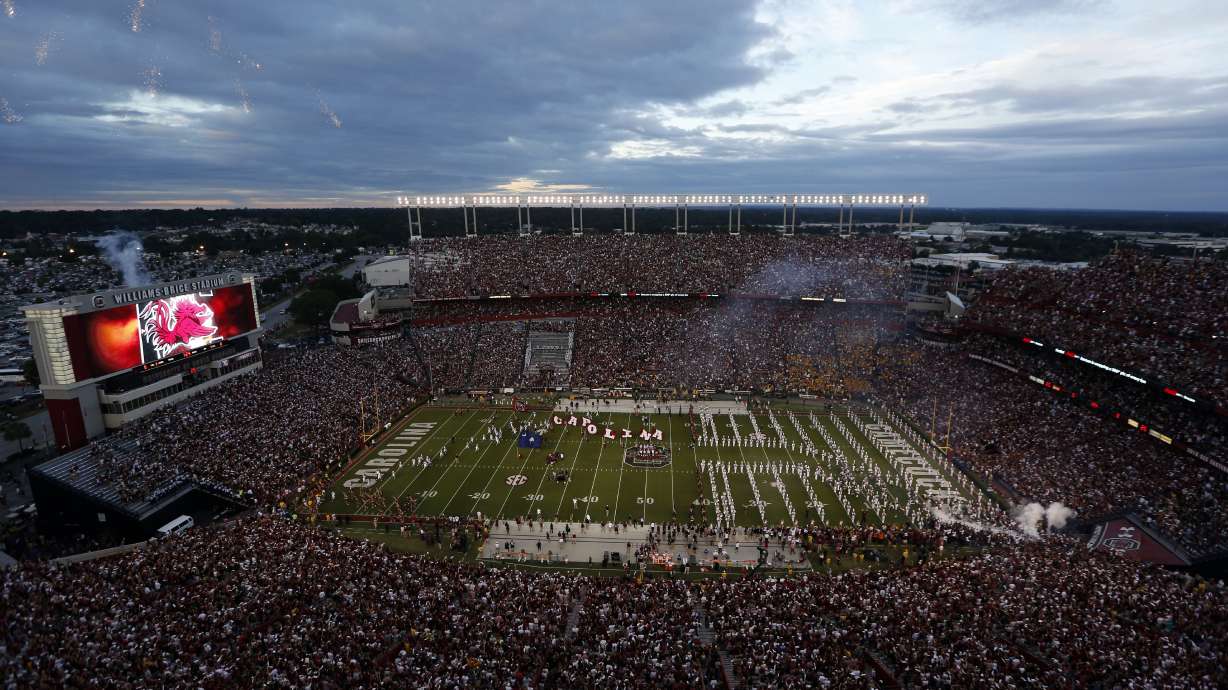FILE - Fans cheer as South Carolina takes the field at William-Brice Stadium before the start of an NCAA college football game against Missouri, Sept. 27, 2014, in Columbia, S.C. Eddie Dunning, who painted the South Carolina Gamecock logo at midfield in Williams-Brice Stadium for 40 seasons, has died, university officials said Wednesday, July 17, 2024.