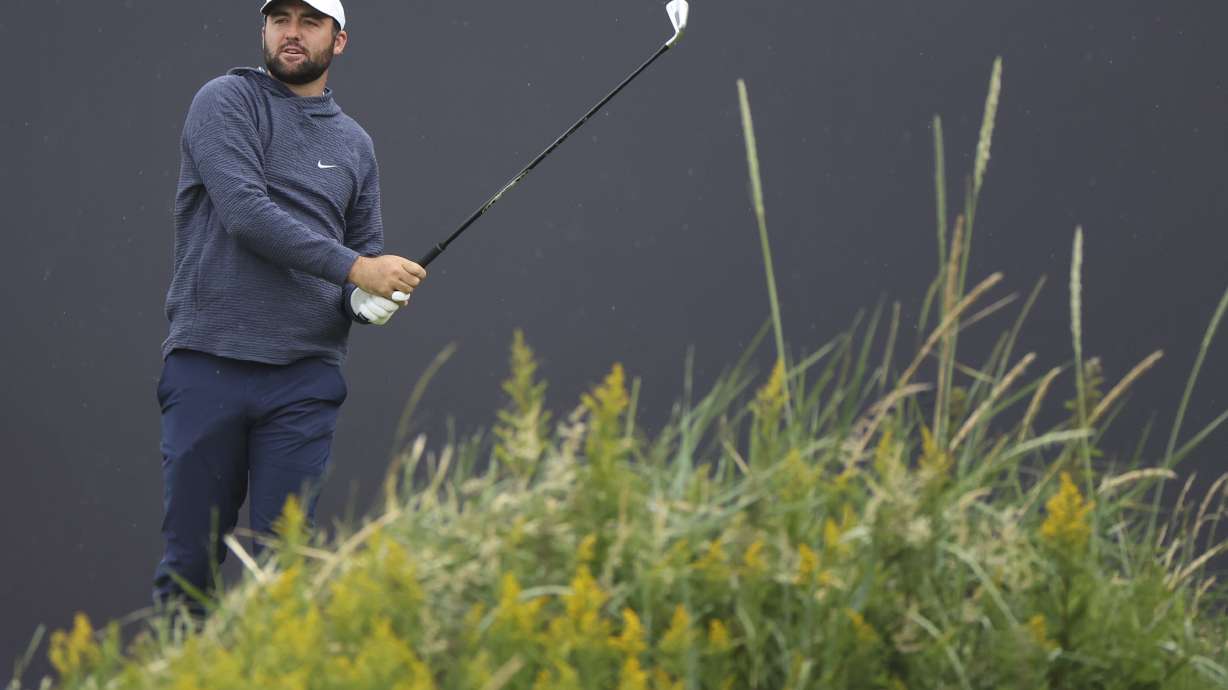 Scottie Scheffler of the United States watches his tee shot on the first hole during a practice round ahead of the British Open Golf Championships at Royal Troon golf club in Troon, Scotland, Tuesday, July 16, 2024.