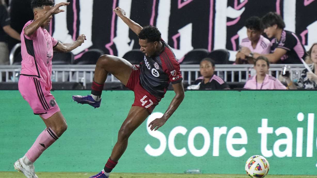 Inter Miami defender Ian Fray, left, takes down Toronto FC midfielder Kosi Thompson during the second half of an MLS soccer match, Wednesday, July 17, 2024, in Fort Lauderdale, Fla.