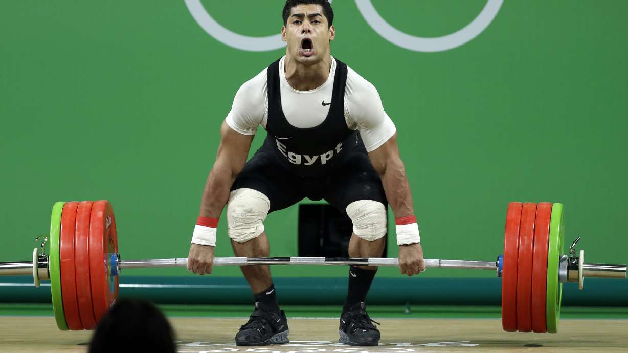 FILE - Mohamed Mahmoud, of Egypt, competes during the men's 77kg weightlifting competition at the 2016 Summer Olympics in Rio de Janeiro, Brazil, Wednesday, Aug. 10, 2016. Weightlifters Mohamed Mahmoud of Egypt and Alexandr Spac of Moldova have returned adverse analytical findings from re-tests of samples from the 2016 Rio Olympics, according to the International Testing Agency, announced this week.