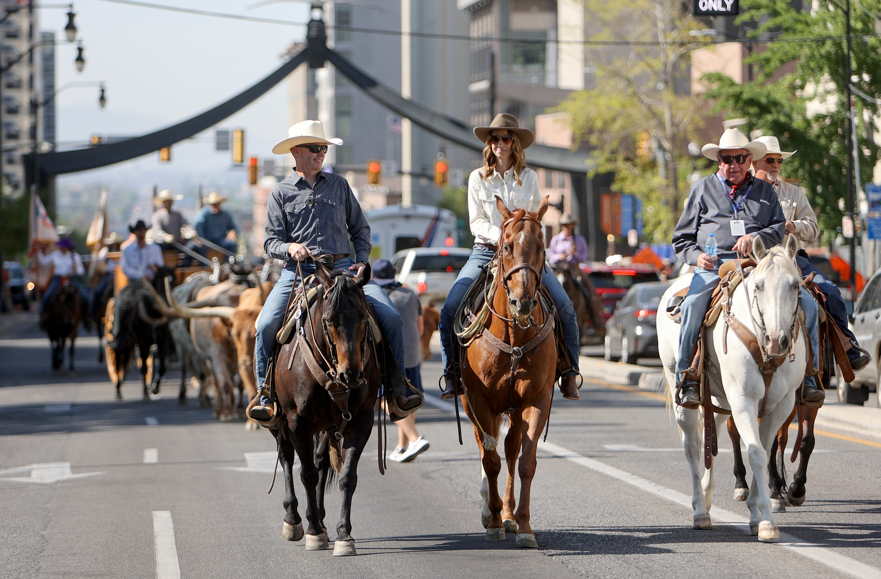 Gov. Spencer Cox and first lady Abby Cox ride in a cattle drive through downtown Salt Lake City to kick off the Days of ’47 Rodeo and pioneer week on Thursday.