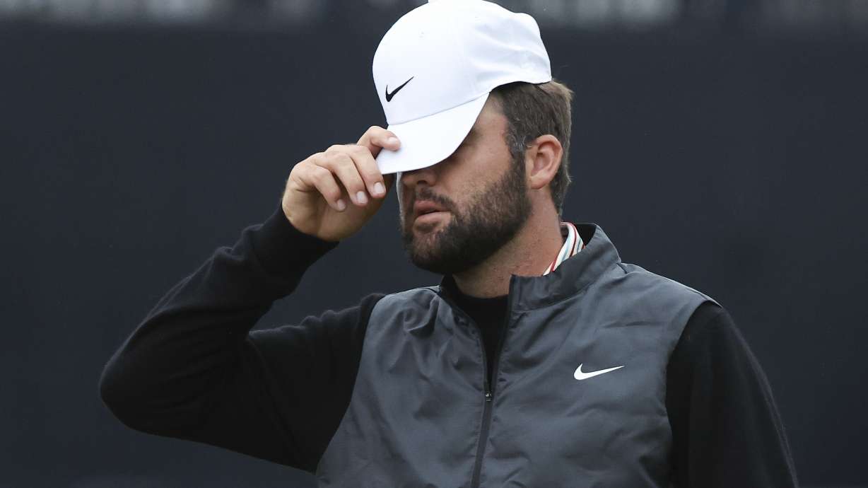 Scottie Scheffler of the United States reacts as he walks from the 18th green following his opening round of the British Open Golf Championships at Royal Troon golf club in Troon, Scotland, Thursday, July 18, 2024.