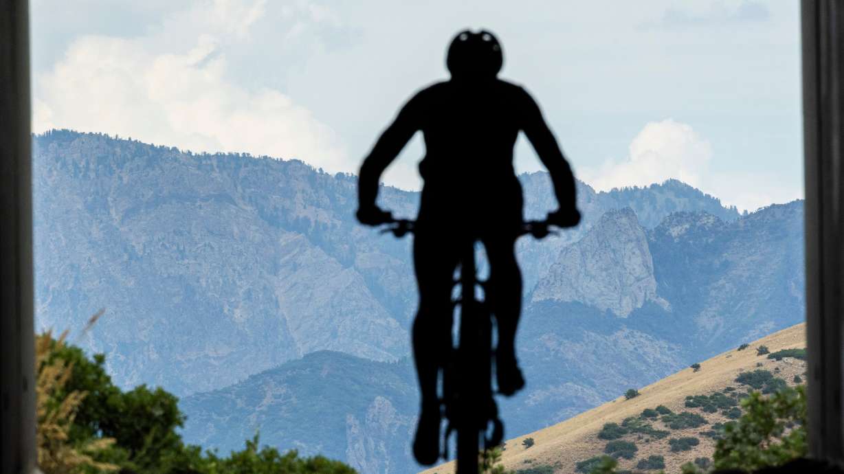 A cyclist rides along a trail near the Potato Hill Trailhead of Corner Canyon in Draper on Thursday. The July heat is taking its deadly toll on hikers.