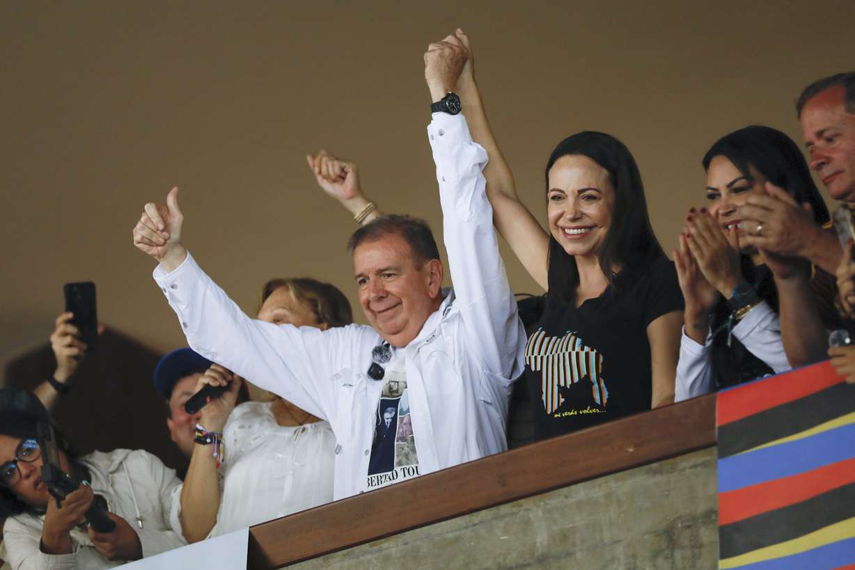 Venezuelan opposition presidential candidate Edmundo Gonzalez, left, and opposition leader Maria Corina Machado raise their arms during a meeting with youth at the Central University of Venezuela in Caracas, Venezuela, on July 14.