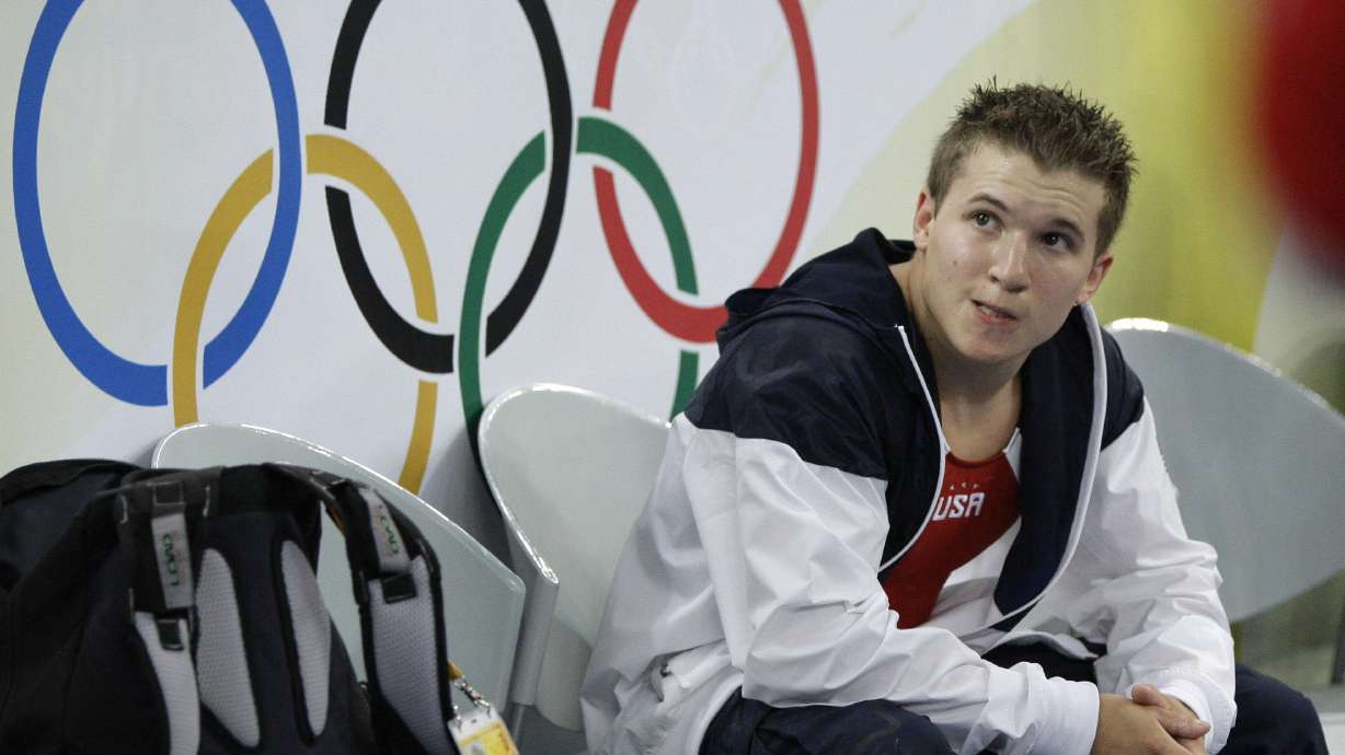 FILE - U.S. gymnast Jonathan Horton sits on the sideline during the men's team final at the Beijing 2008 Olympics in Beijing, Tuesday, Aug. 12, 2008. Former American gymnast Jonathan Horton figures the difference between winning silver and gold at the Olympics cost him seven-figures in endorsement opportunities.