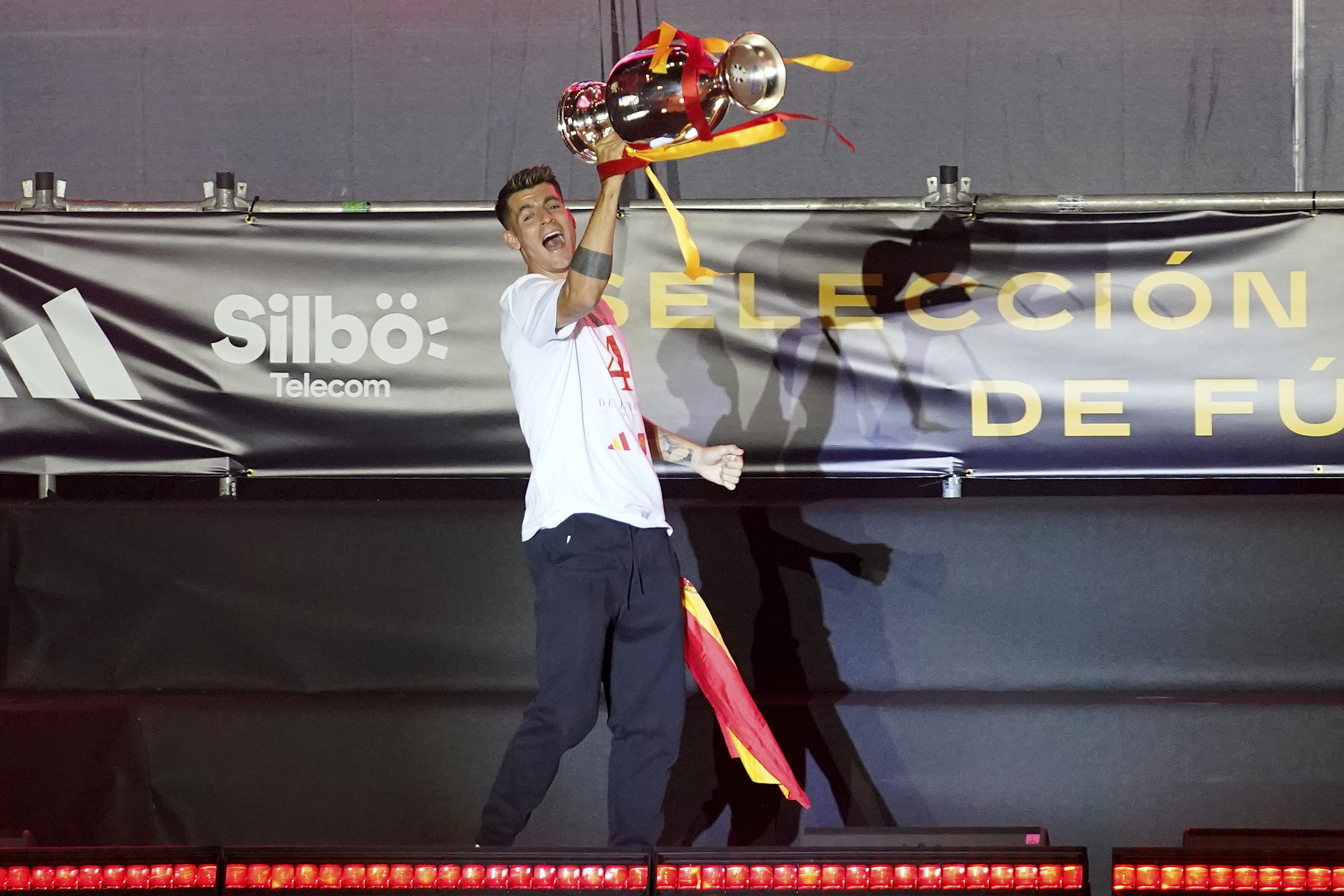Spain's team captain Alvaro Morata arrives on stage carrying the trophy during celebrations of the Spanish team's European soccer championship title on a stage at Cibeles square in Madrid, Monday, July 15, 2024. Spain defeated England in the final of the Euro 2024 soccer tournament in Berlin on Sunday evening.