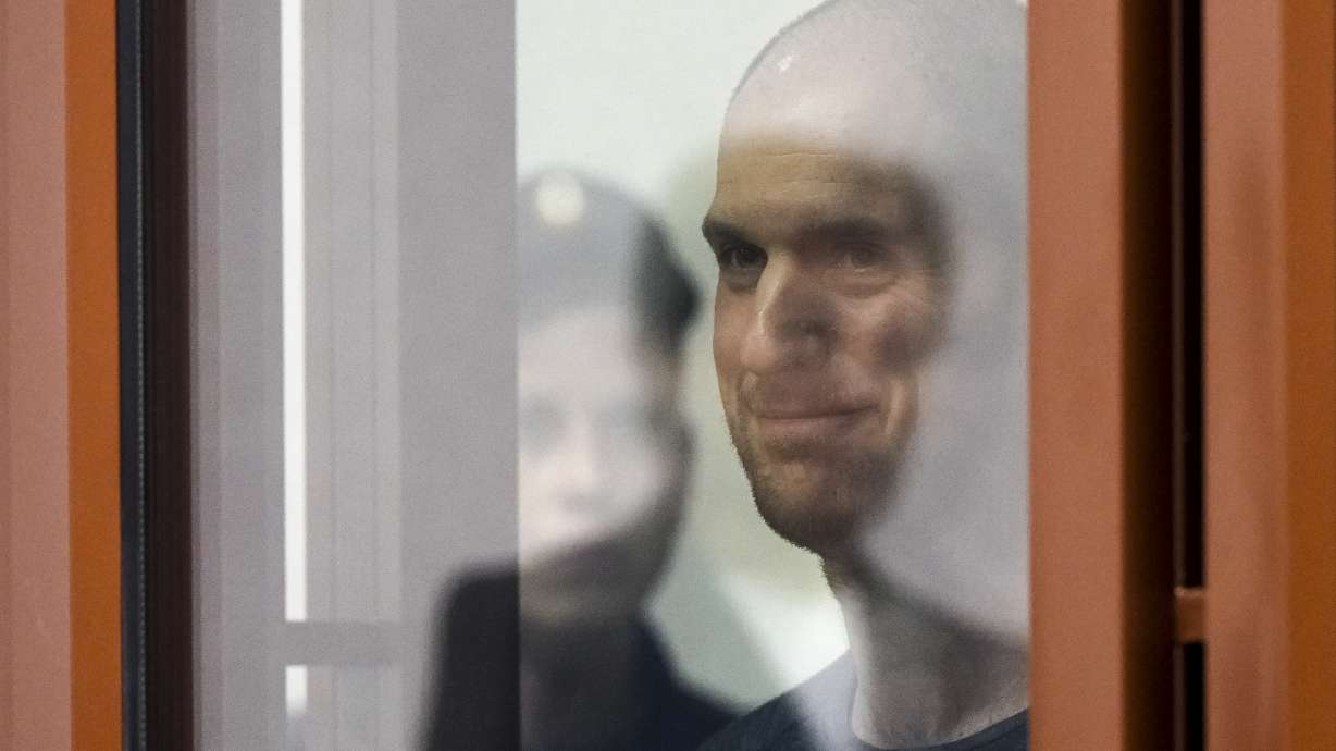 Wall Street Journal reporter Evan Gershkovich stands listening to the verdict in a glass cage inside the "Palace of justice," in Yekaterinburg, Russia, Friday. A Russian court convicted him on espionage charges and sentenced him to 16 years in prison.