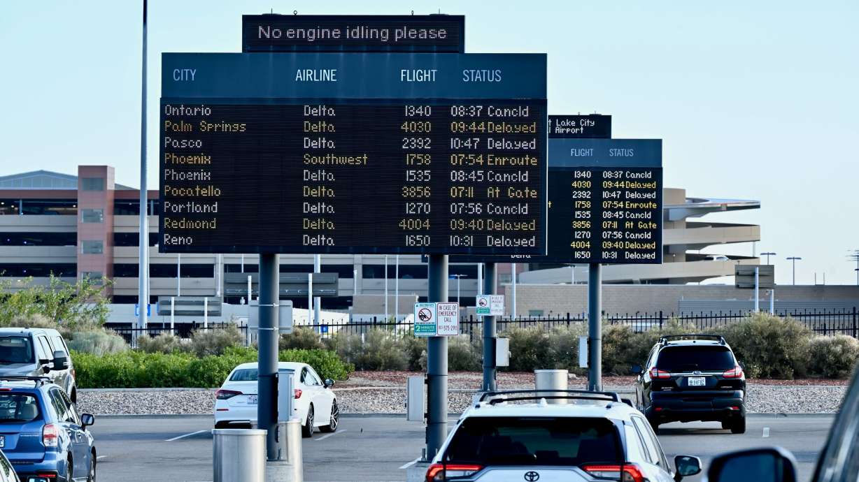 A screen in the standby lot shows multiple canceled and delayed flights at the Salt Lake City International Airport in Salt Lake City on Friday. A global technology outage grounded flights, knocked banks and hospital systems offline and media outlets off air on Friday.