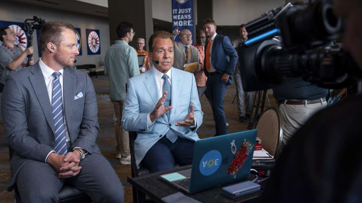 ESPN commentators Nick Saban, right, and Greg McElroy speak during the Southeastern Conference NCAA college football media days Wednesday, July 17, 2024, in Dallas.