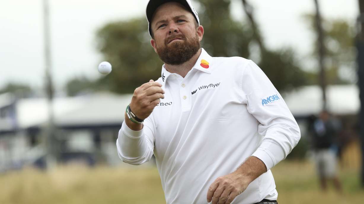 Shane Lowry of Ireland throws his ball into the stands as he walks from the 18th green following his second round of the British Open Golf Championships at Royal Troon golf club in Troon, Scotland, Friday, July 19, 2024.