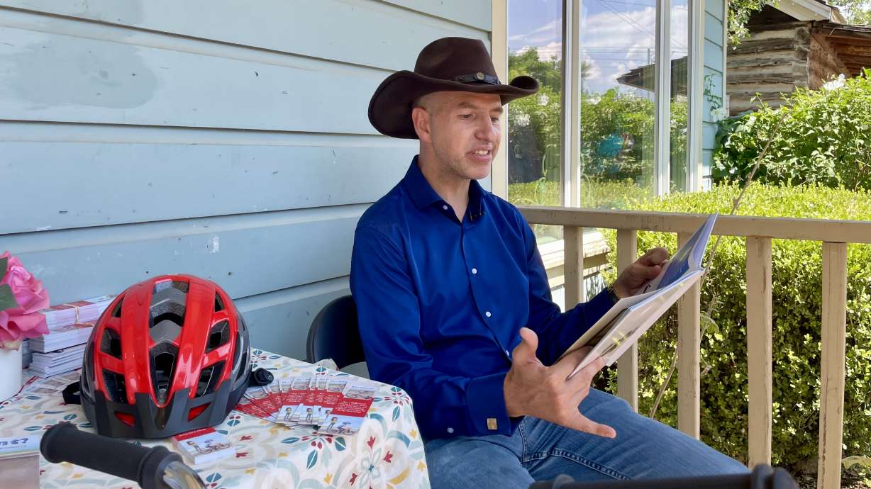 Johnathan Aubrey, a Utah man with cerebral palsy, reads from his recently published children's book "Am I Different?" at Storybook Nook in West Jordan on July 19.