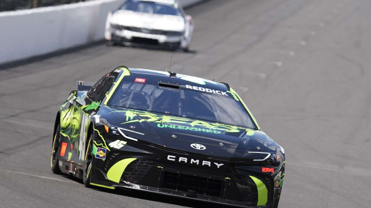 Tyler Reddick drives into a turn during a practice session for the NASCAR Cup Series auto race at Indianapolis Motor Speedway, Friday, July 19, 2024, in Indianapolis.