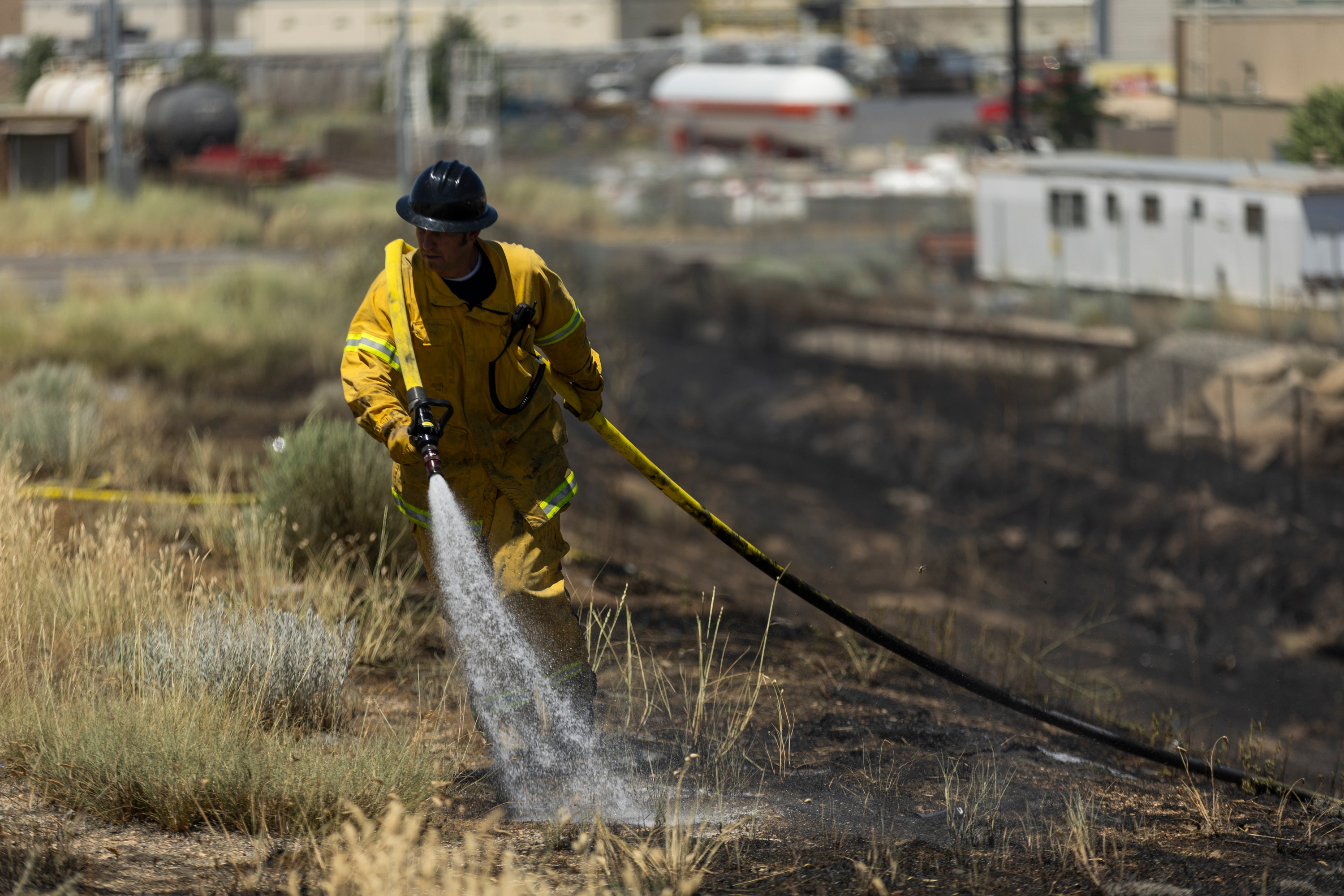Firefighters work to contain a brush fire off of I-215 West in Salt Lake City on June 30. Utah collected above-average precipitation throughout the first half of this year, but "abnormally dry" conditions are returning amid a precipitation lull that began in April.