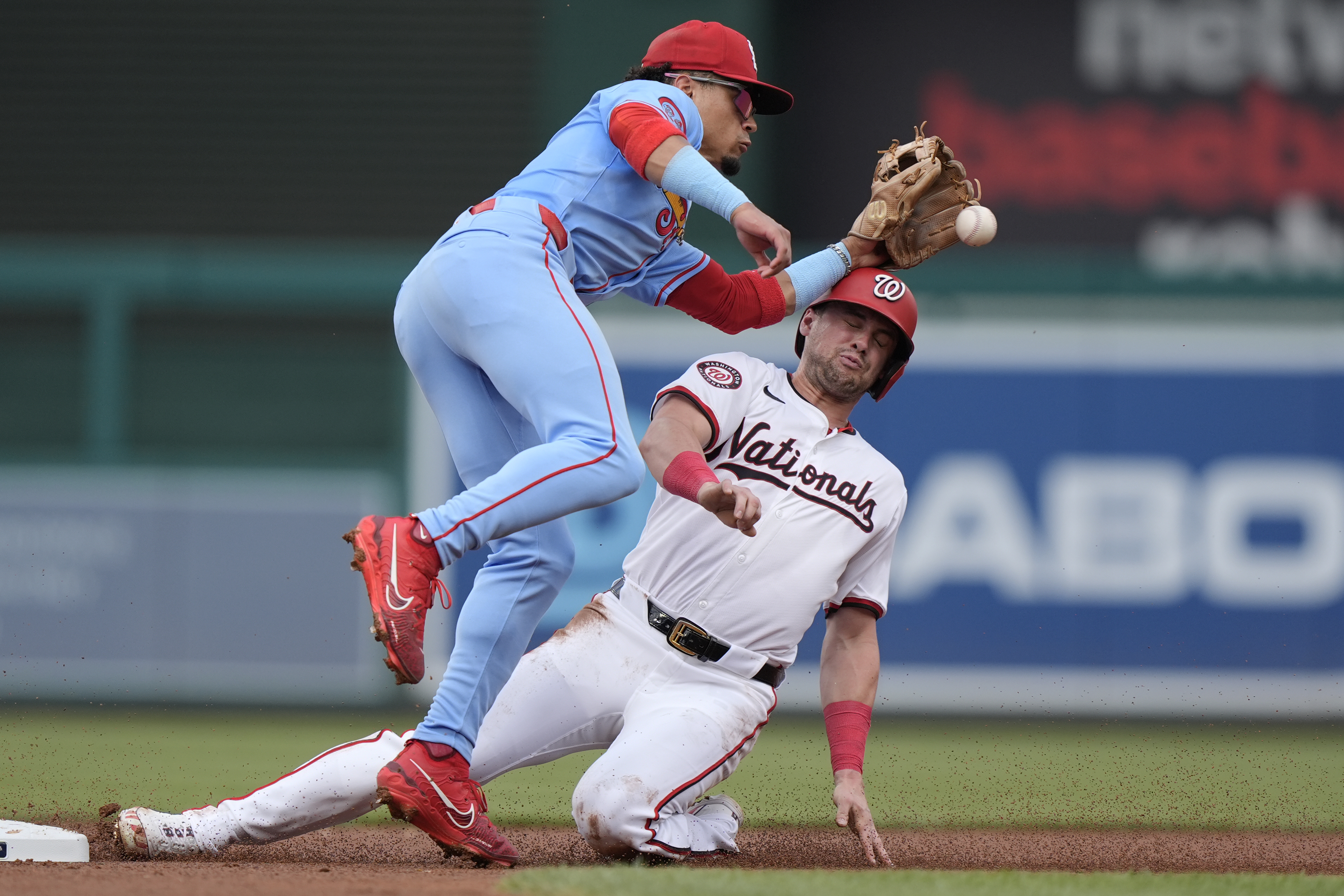Washington Nationals' Lane Thomas, right, collides with St. Louis Cardinals shortstop Masyn Winn, left, while stealing second base during the first inning of a baseball game at Nationals Park, Saturday, July 6, 2024, in Washington.