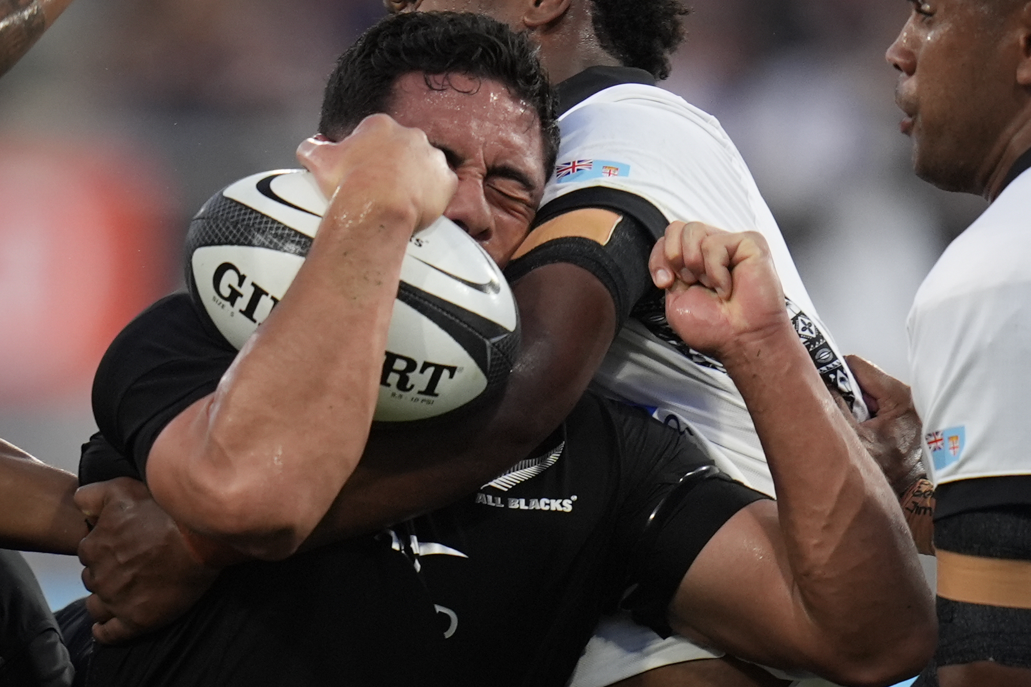 New Zealand's Anton Lienert-Brown holds on to the ball as he is tackled during the first half of a rugby test match against Fiji, Friday, July 19, 2024, in San Diego.