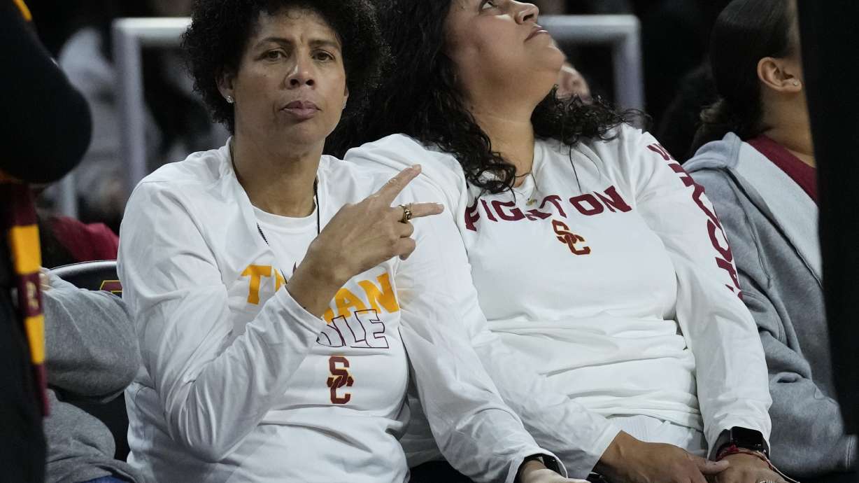 FILE - Basketball Hall of Famer Cheryl Miller, left, greets fans during the first half of an NCAA college basketball game against UCLA in Los Angeles, Sunday, Jan. 14, 2024. Miller will coach the WNBA All-Stars against Team USA during All-Star weekend on Saturday, July 20, 2024.