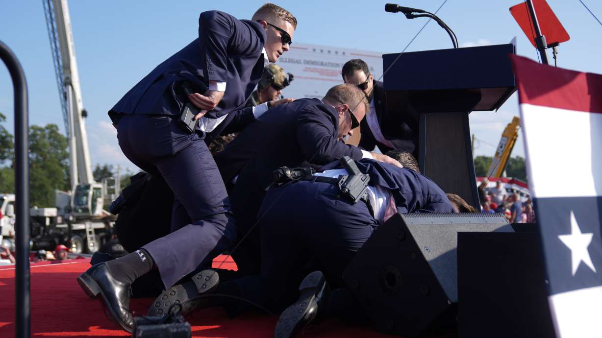 Republican presidential candidate former President Donald Trump is covered by U.S. Secret Service agents at a campaign rally in Butler, Pa., on July 13.