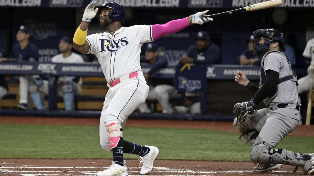 New York Yankees catcher Austin Wells, right, watches as Tampa Bay Rays' Yandy Díaz hits a fly ball off the catwalk in center field during the first inning of a baseball game Thursday, July 11, 2024, in St. Petersburg, Fla.