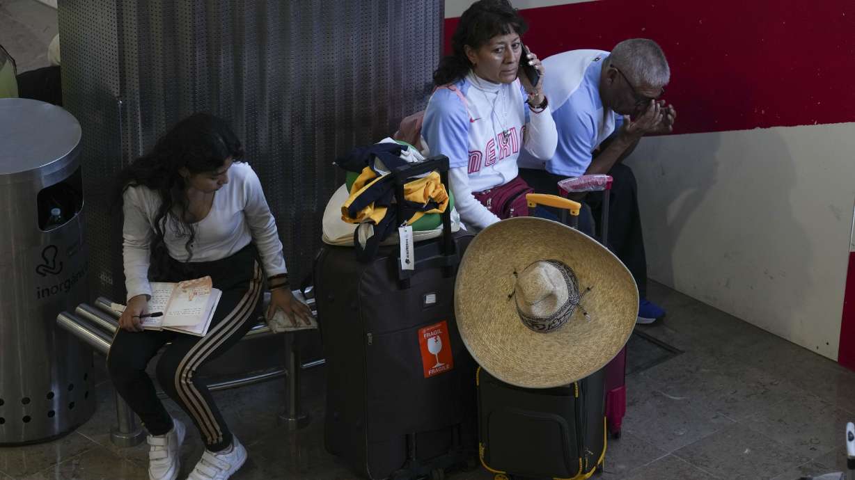 Passengers wait at Benito Juárez International Airport in Mexico City, Friday. Some flights were canceled and others were delayed amid a global technology outage.