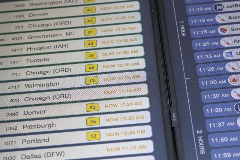 Delayed flight schedules are displayed on a screen at LaGuardia Airport in New York on Friday, after a faulty CrowdStrike update caused a major internet outage for computers running Microsoft Windows.