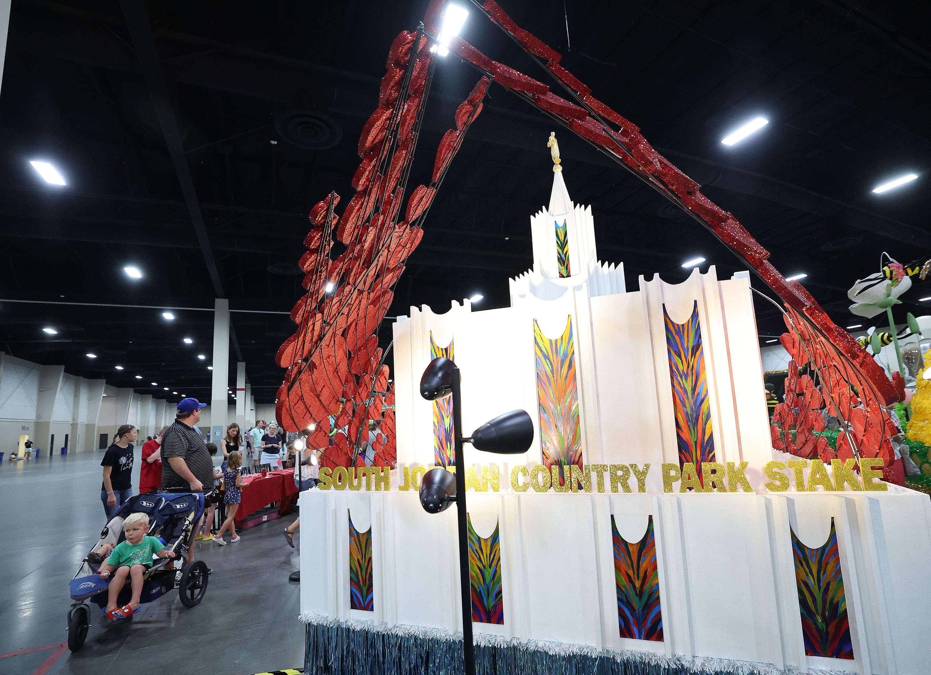 The public looks over the South Jordan Country Park Stake float and other Days of '47 Parade floats during a preview at the Mountain America Expo Center in Sandy on Saturday.