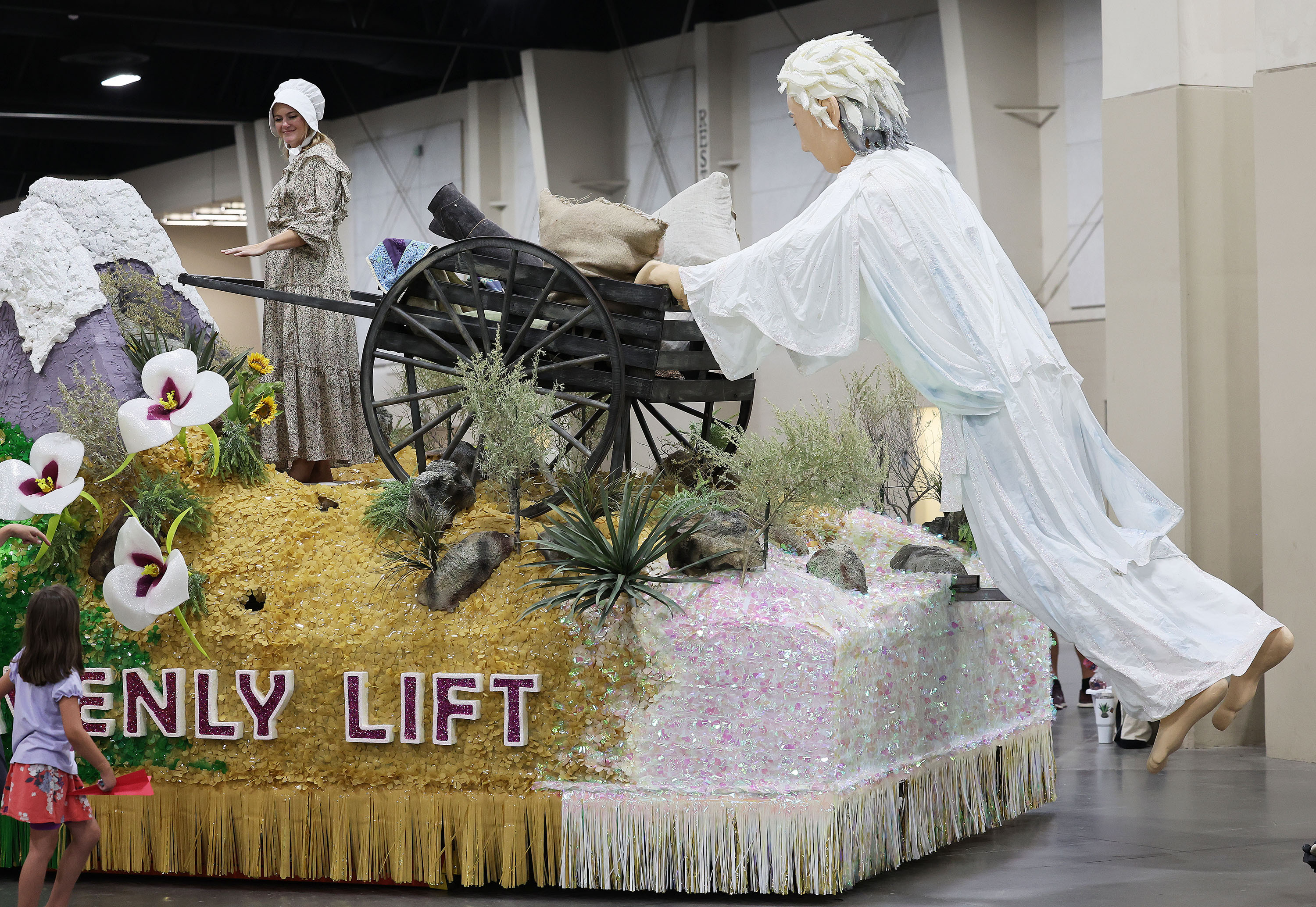 The public looks over the Midvale Utah Union Park Stake float and other Days of '47 Parade floats during a preview at the Mountain America Expo Center in Sandy on Saturday.