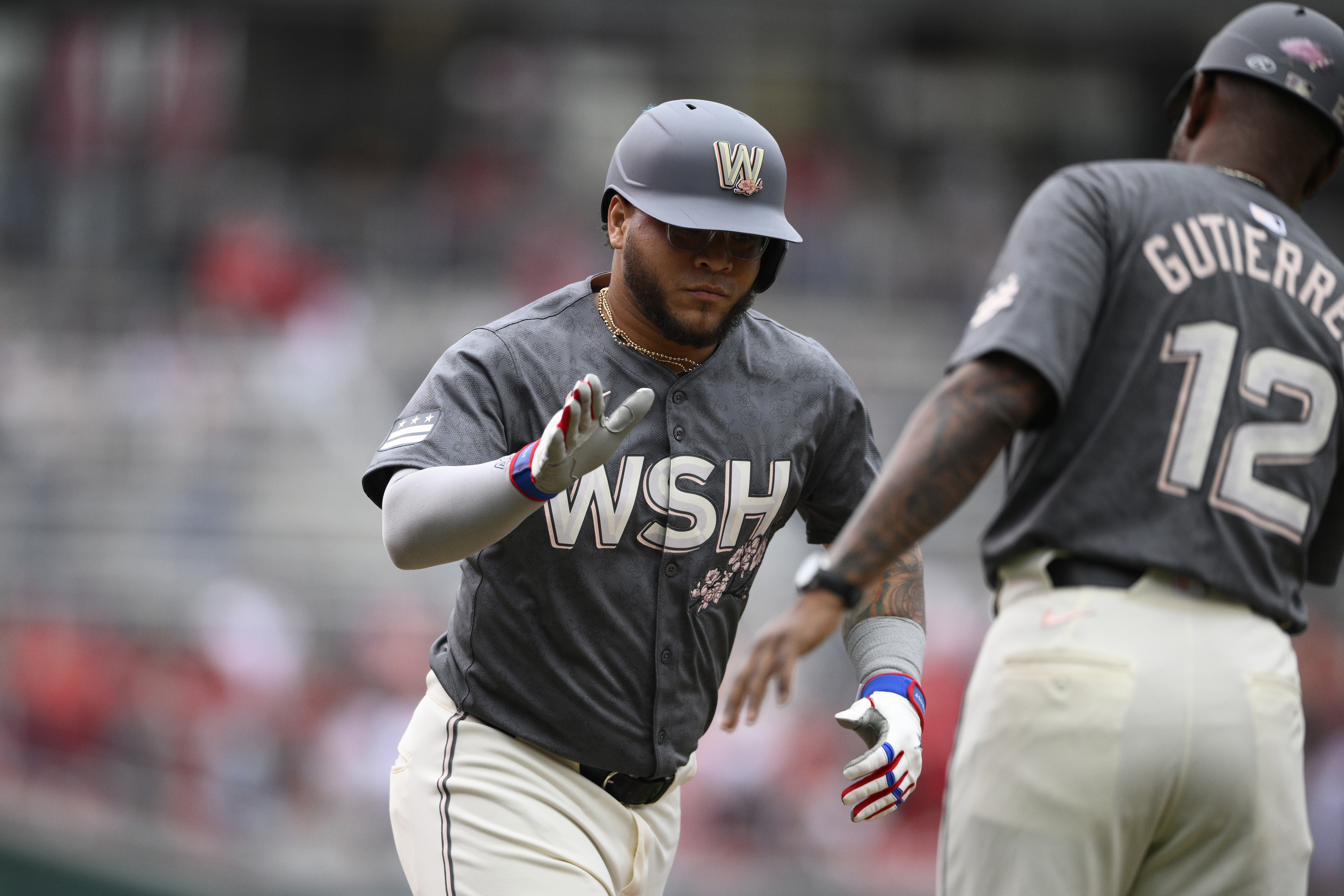 Washington Nationals' Harold Ramirez, left, celebrates after his two-run home run with Ricky Gutierrez (12) during the first inning of a baseball game against the Cincinnati Reds, Saturday, July 20, 2024, in Washington.