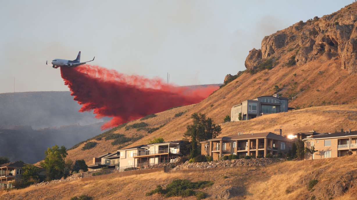 A plane drops fire retardant above Ensign Peak July 20, 2024. Utah is poised to be the newest Great Plains Interstate Fire Compact member after Gov. Spencer Cox signed a bill on Monday.