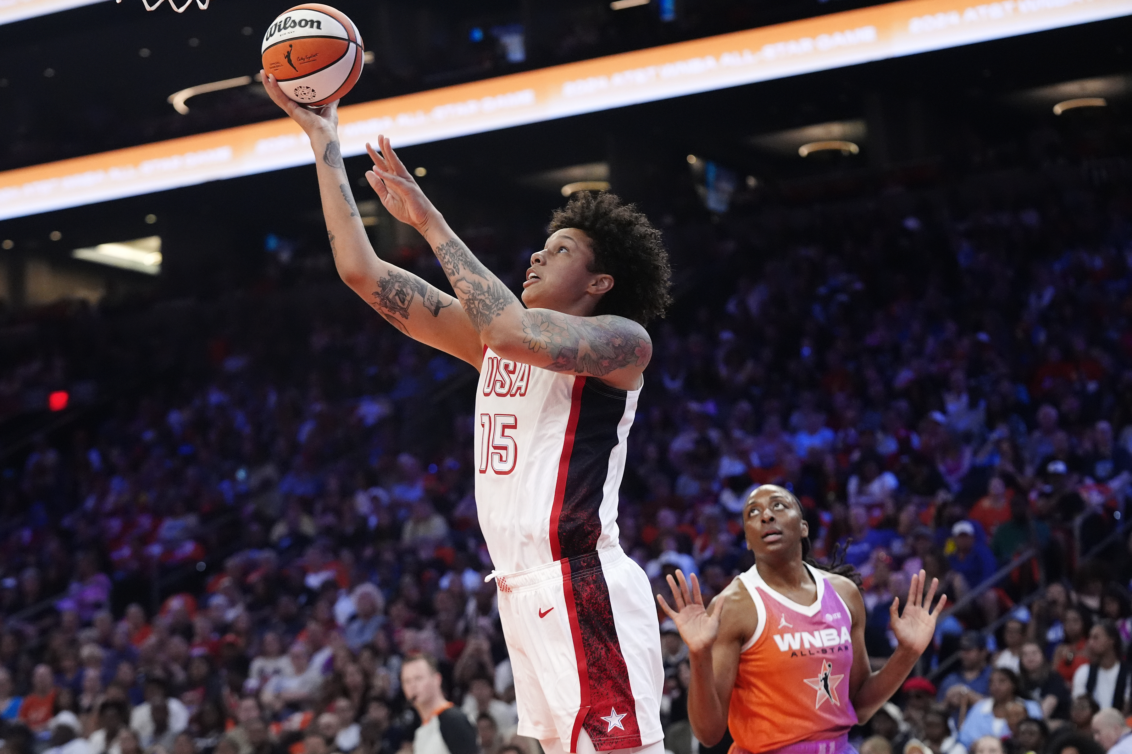 Brittney Griner, left, of Team USA, gets past Nneka Ogwumike, right, of Team WNBA, to score during the first half of a WNBA All-Star basketball game Saturday, July 20, 2024, in Phoenix. 