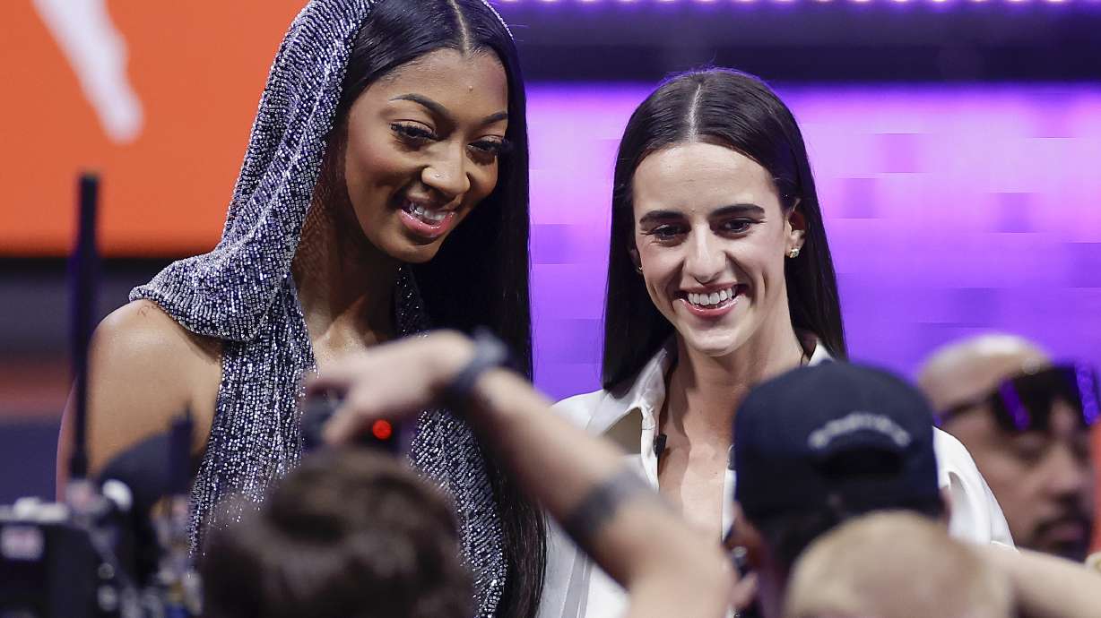 FILE - LSU's Angel Reese, left, and Iowa's Caitlin Clark, right, pose for a photo before the WNBA basketball draft, Monday, April 15, 2024, in New York. Caitlin Clark and Angel Reese will once again step into the spotlight during All-Star Weekend with their matchup against Team USA.