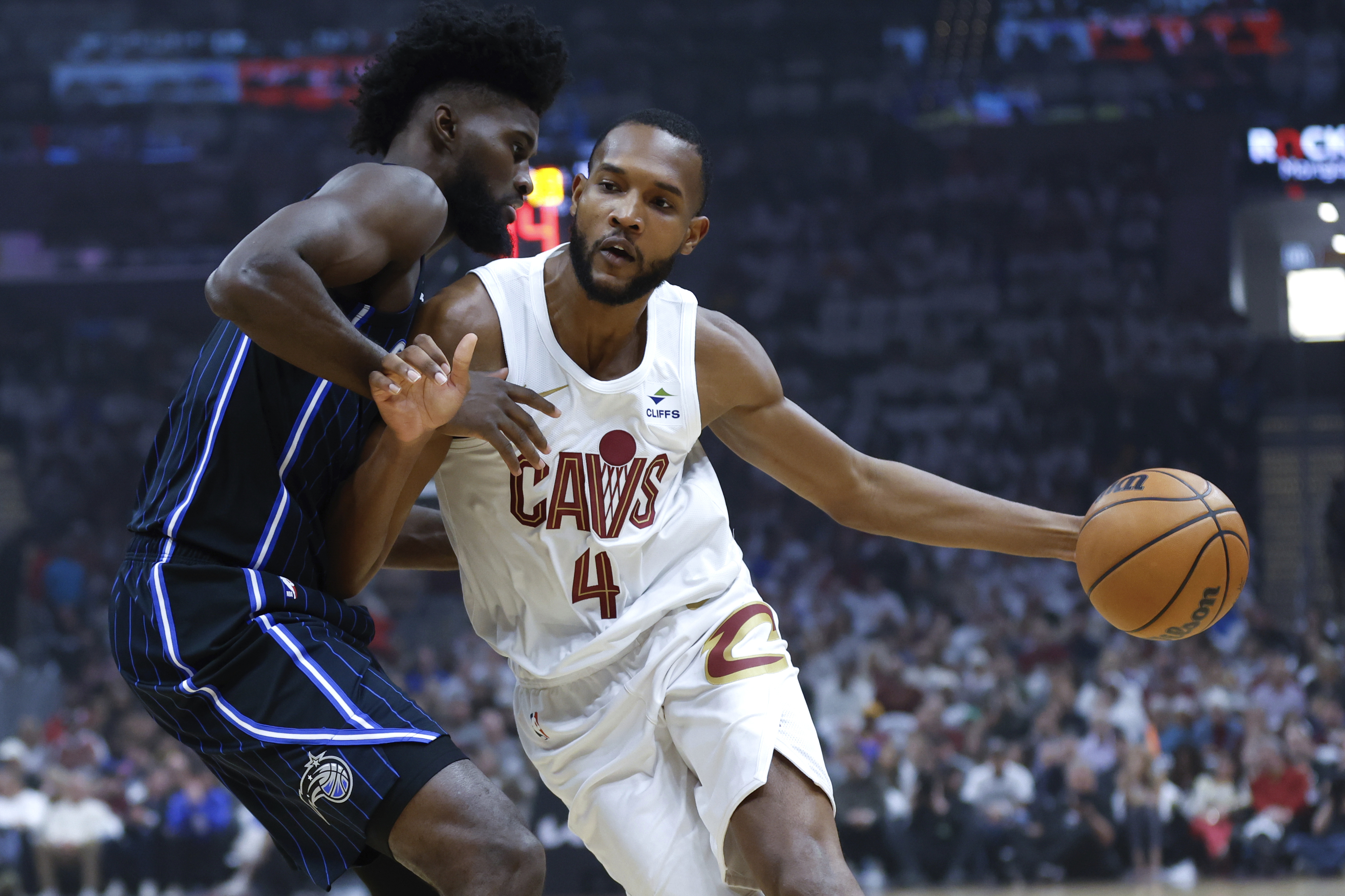 FILE - Cleveland Cavaliers forward Evan Mobley (4) drives against Orlando Magic forward Jonathan Isaac during the first half of Game 2 of an NBA basketball first-round playoff series, April 22, 2024, in Cleveland. Mobley has agreed to a five-year, $224 million contract extension with Cleveland, a person familiar with the negotiations told The Associated Press on Saturday, July 20.