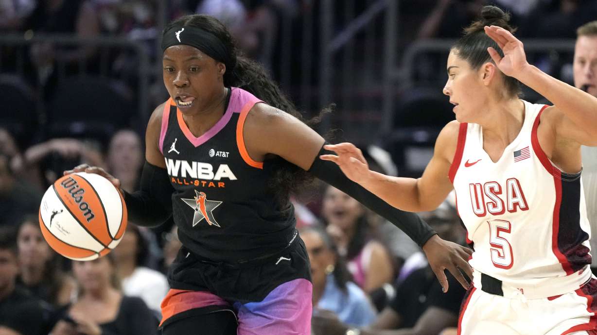 Arike Ogunbowale, left, of Team WNBA, left, steals a pass intended for Kelsey Plum (5), of Team USA, during the second half of a WNBA All-Star basketball game Saturday, July 20, 2024, in Phoenix.