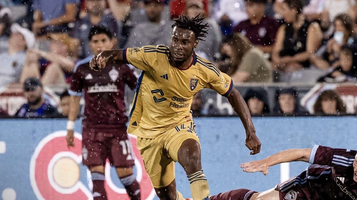 Emeka Eneli, middle, dribbles away from Colorado defenders.