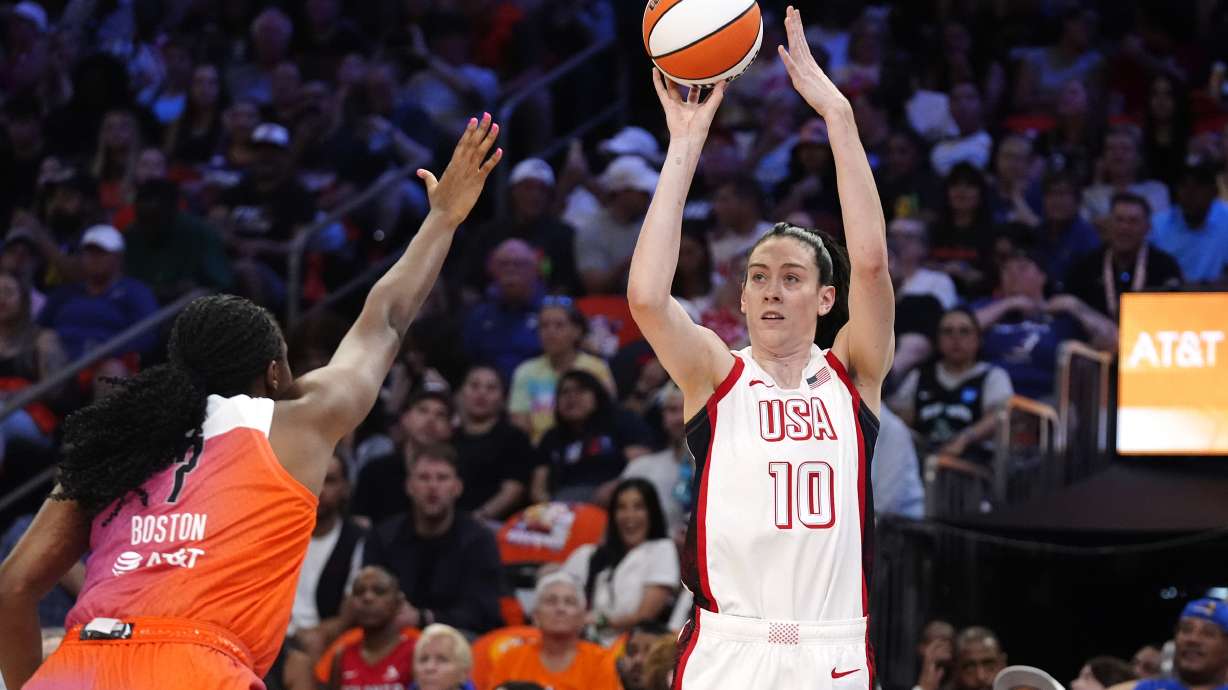 Breanna Stewart (10), of Team USA, looks to shoot a 3-point basket over Aliyah Boston, of Team WNBA, during the first half of a WNBA All-Star basketball game Saturday, July 20, 2024, in Phoenix.