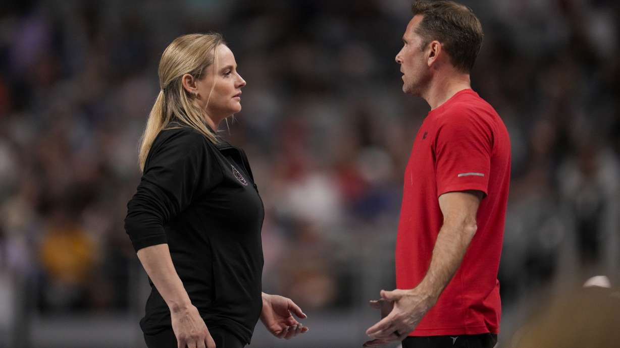 FILE - Cecile & Laurent Landi, coaches of Simone Biles, chat before she participates on the vault during the U.S. Gymnastics Championships, Sunday, June 2, 2024, in Fort Worth, Texas. The Landis are have a homecoming of sorts at the Paris Olympics when the French natives help lead Biles and a U.S. women's gymnastics team heavily favored to win gold.