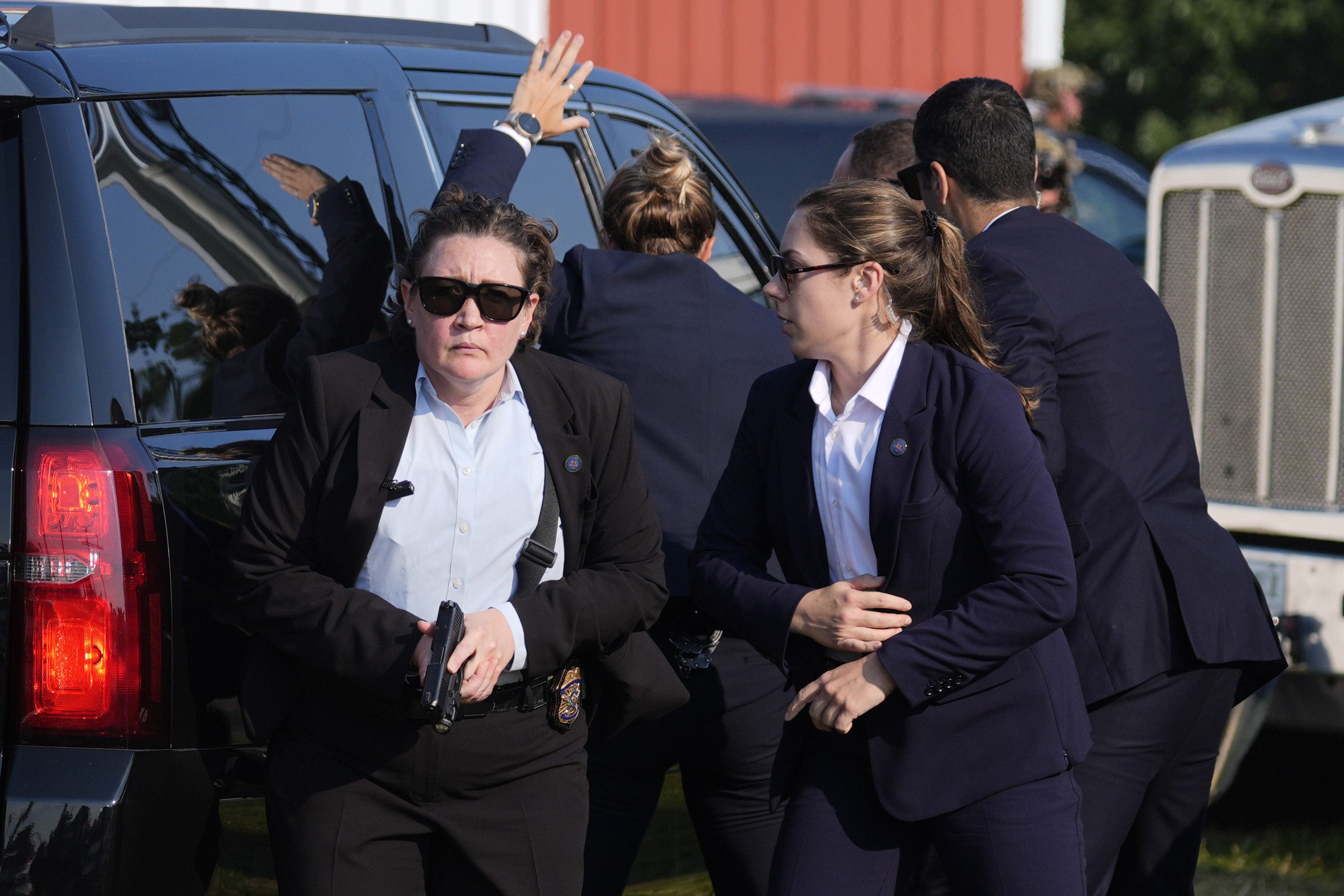 U.S. Secret Service agents surround the vehicle carrying Republican presidential candidate former President Donald Trump at a campaign rally, July 13, in Butler, Pa.