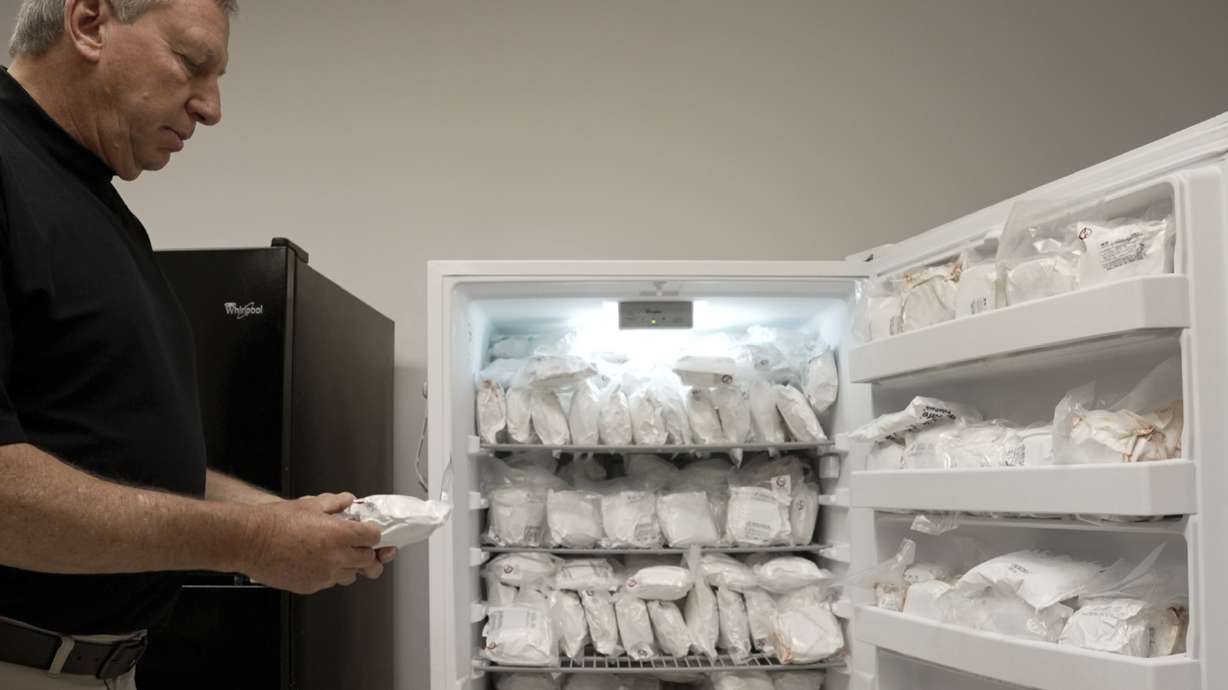 David Ayares holds a package of frozen meat in Blacksburg, Va., on May 30. His company genetically modified pigs, known as GalSafe pigs, so they no longer carry a sugar responsible for alpha-gal syndrome, an allergy to red meat.