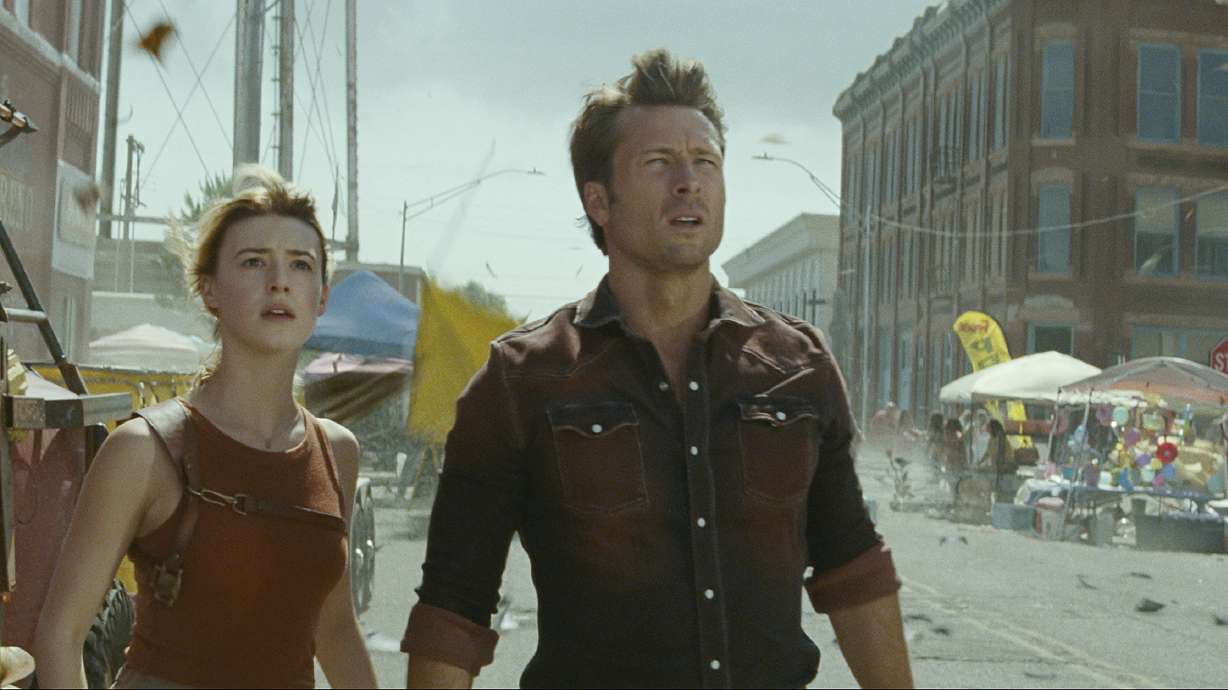 This image released by Universal Pictures shows Glen Powell, right, and Daisy Edgar-Jones in a scene from "Twisters."