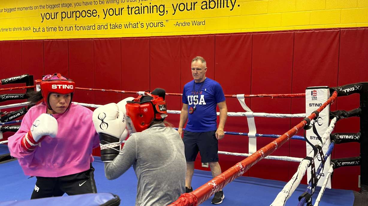 U.S. Olympic boxer Jajaira Gonzalez, left, spars with teammate Jennifer Lozano while head coach Billy Walsh looks on at the U.S. Olympic Training Center in Colorado Springs, Colo., June 14, 2024. Eight years after Gonzalez narrowly missed out on qualification for the Rio de Janeiro Games, she revived her boxing career and earned an Olympic berth in Paris.