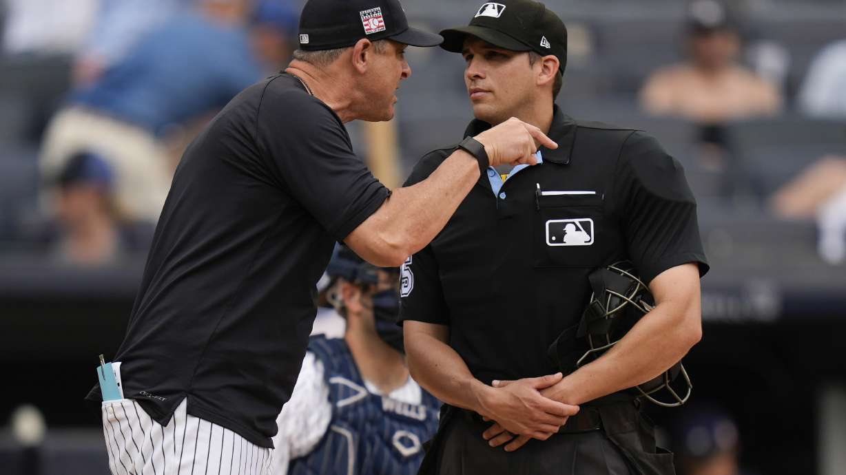 New York Yankees manager Aaron Boone, left, yells at umpire Edwin Jimenez, right, during the sixth inning of a baseball game against the Tampa Bay Rays at Yankee Stadium Sunday, July 21, 2024, in New York. Boone was ejected from the game.