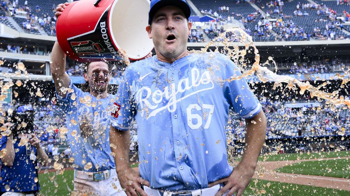 Kansas City Royals starting pitcher Seth Lugo (67) is doused with ice water by Bobby Witt Jr. after pitching a complete game in their win over the Chicago White Sox during a baseball game, Sunday, July 21, 2024, in Kansas City, Mo.