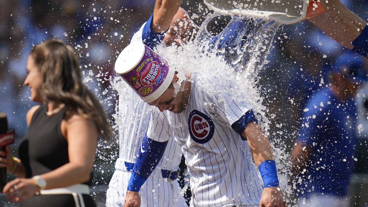 Chicago Cubs' Nico Hoerner is doused with water after he was walked by Arizona Diamondbacks pitcher Humberto Castellanos, forcing in a run by Mike Tauchman to win the baseball game 2-1, Sunday, July 21, 2024, in Chicago.