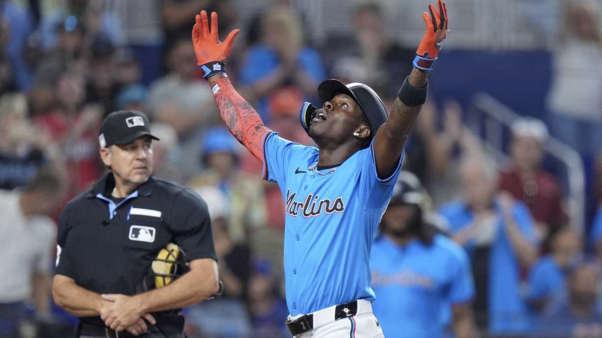 Miami Marlins' Jazz Chisholm Jr. celebrates as he crosses home plate after hitting a home run scoring Xavier Edwards and Vidal Bruján, during the fourth inning of a baseball game against the New York Mets, Sunday, July 21, 2024, in Miami.